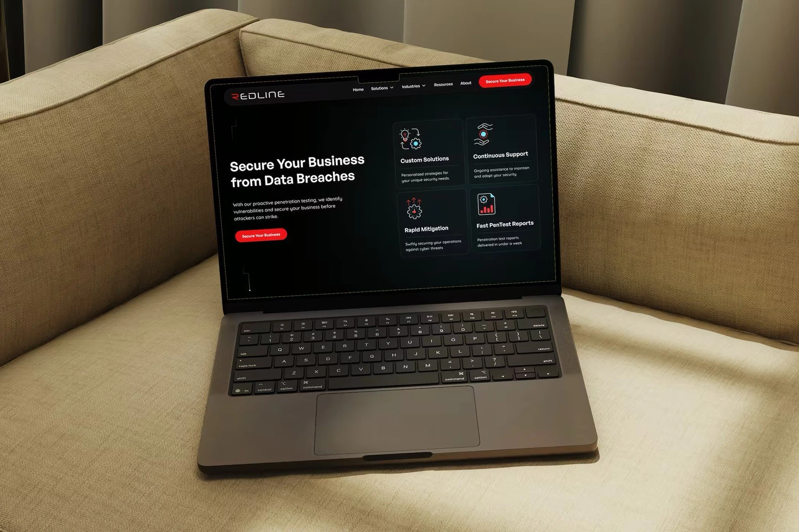 The Redline Cyber Security homepage on a laptop resting on a linen sofa, its dark hero reading Secure Your Business from Data Breaches
