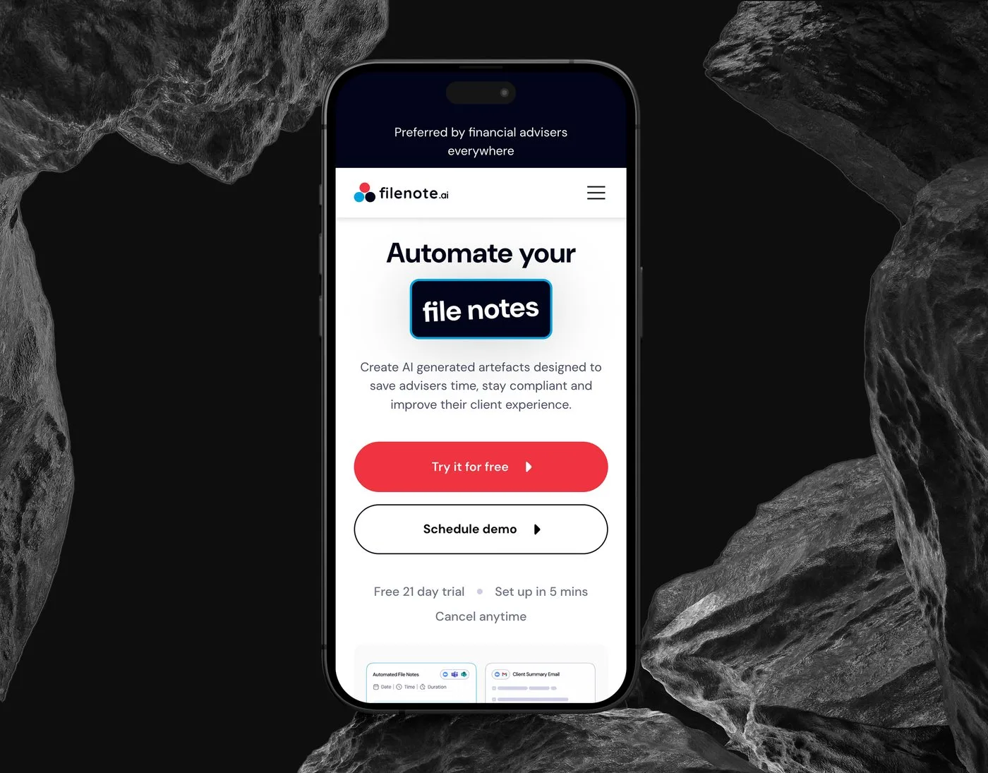 The Filenote.ai mobile homepage on an iPhone set upright between dark rocks — the "Automate your file notes" headline above the Try it for free button.