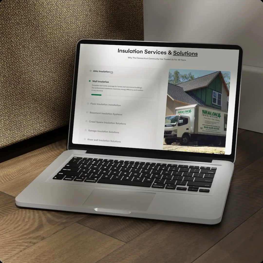 The Nealon Insulation services page on a laptop on a timber floor, showing the Insulation Services & Solutions accordion of attic, wall, floor and crawl-space options beside a photo of the branded Nealon box truck outside a house.