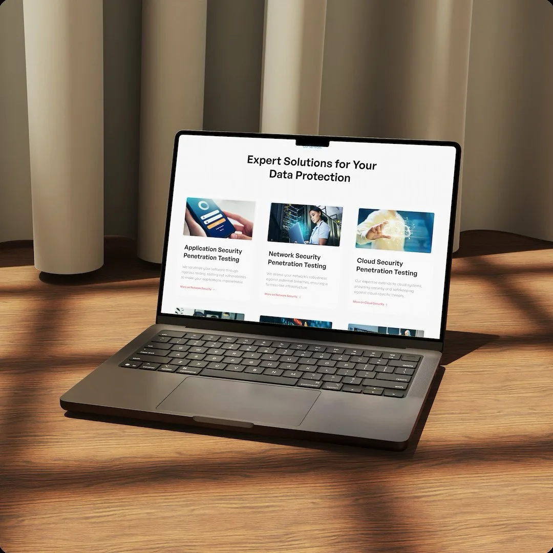 The Redline Cyber Security services section on a laptop angled on a timber floor in raking light, headed Expert Solutions for Your Data Protection with cards for Application, Network and Cloud Security Penetration Testing.